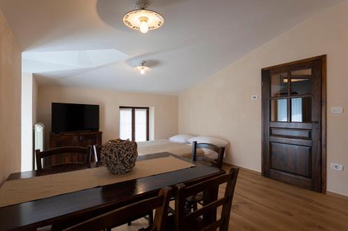 a living room with a dining room table and a bed at Guest House Valentincic in Nova Gorica