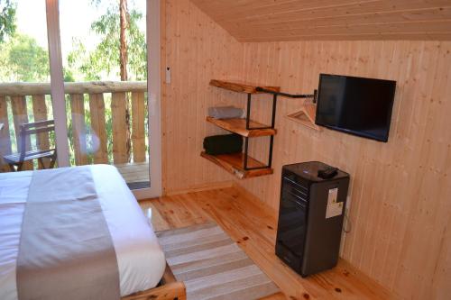 a bedroom with a bed and a flat screen tv at MountView in Alenquer
