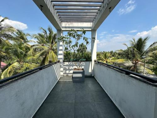 a balcony with a view of the palm trees at Beauty World Villa - Gampaha in Gampaha