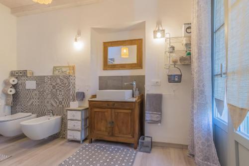 a bathroom with a sink and a toilet and a tub at Green Garden House in Lierna