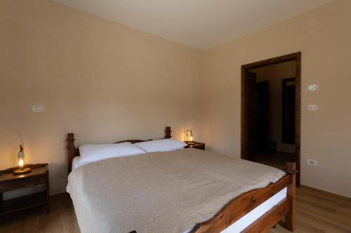 a bedroom with a large bed with two night stands at Guest House Valentincic in Nova Gorica