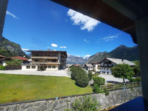 a view of a building with mountains in the background at Apart Emilia in Schlitters