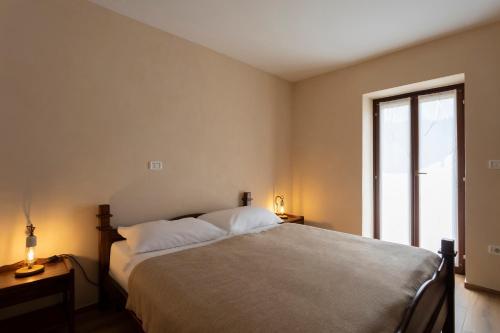 a bedroom with a bed and a large window at Guest House Valentincic in Nova Gorica