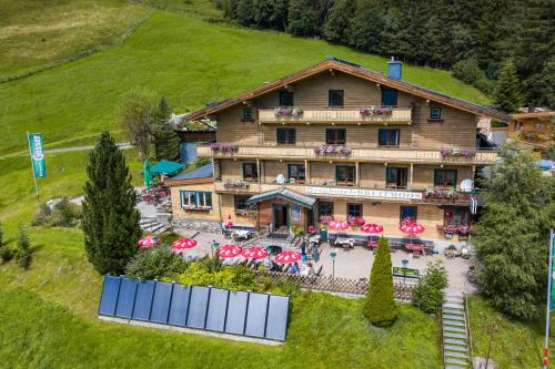 an aerial view of a house with tables and chairs at Berghotel Breitmoos in Mittersill