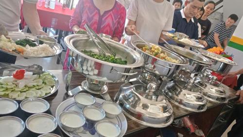 a buffet with many plates of food on a table at Hotel Kanthak in Lumbini