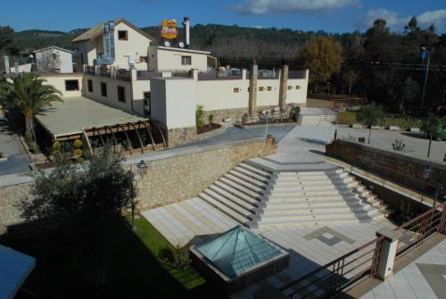 a building with a bunch of stairs in front of it at Hotel Al Ritrovo in Piazza Armerina