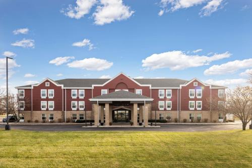 a large red brick building with a gazebo at Redwood Lodge in Redwood Falls