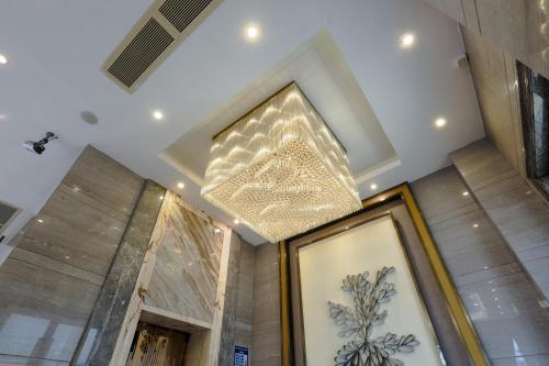 a ceiling with a chandelier in a room at MIZPARTON HOTEL - Heshan New Town in Jiangmen