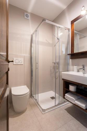 a bathroom with a shower and a toilet and a sink at Guest House Valentincic in Nova Gorica