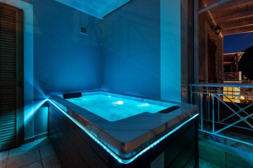 a hot tub in a room with blue lighting at Villa Semipuella in Agios Nikitas