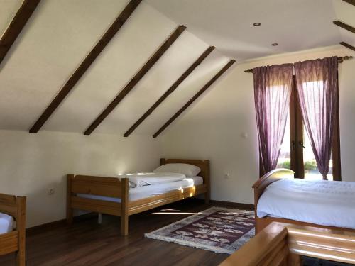 a bedroom with two beds and a window at Vikendice - Vodenica Jurić in Prozor