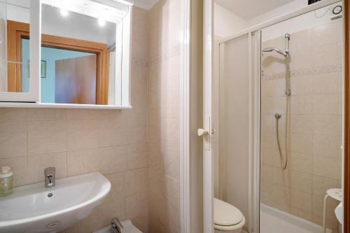 a bathroom with a sink and a toilet and a shower at Monolocale La Pineta 46 in Albenga