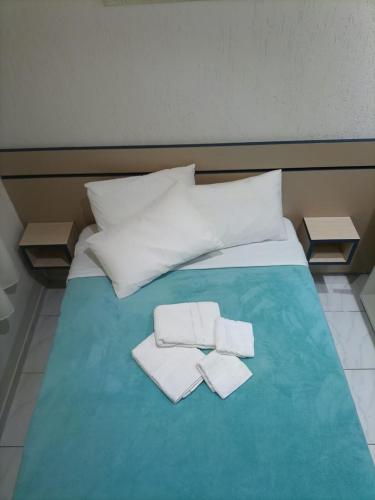 a bed with two towels on top of it at Cantinho Aconchego in Santo Antônio do Pinhal