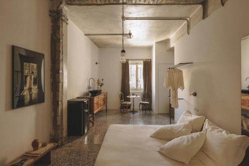a bedroom with a bed and a table in a room at Mona Athens in Athens