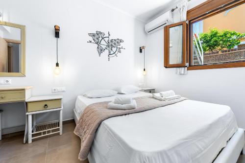 two beds in a white room with a window at Villa Semipuella in Agios Nikitas
