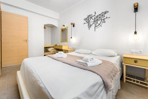 a bedroom with a large bed with towels on it at Villa Semipuella in Agios Nikitas