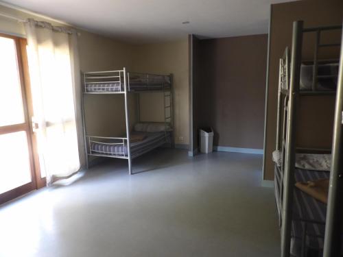 an empty room with bunk beds and a window at Gite 20 places in Razès