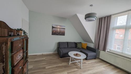 a living room with a couch and a table at Albertine 2 in Quedlinburg