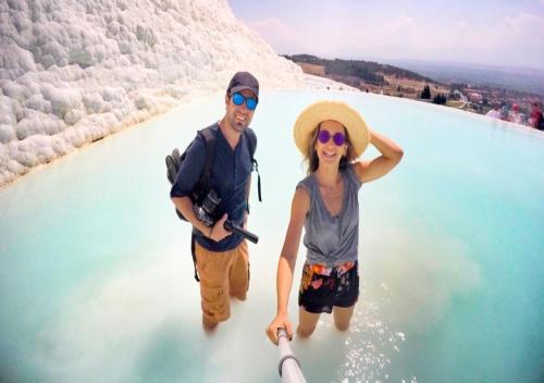 a man and a woman standing in a pool of water at Oskar Thermal Hotel in Pamukkale