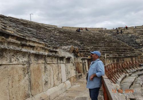 a man standing in front of an amphitheater at Oskar Thermal Hotel in Pamukkale