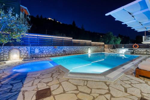 a swimming pool in a resort at night at Villa Semipuella in Agios Nikitas