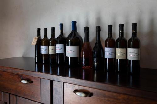 a group of wine bottles sitting on top of a dresser at Guest House Valentincic in Nova Gorica