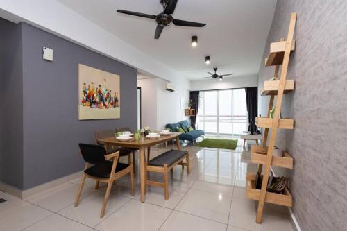 a dining room and living room with a table and chairs at Dream - Summer @Majestic Condo in Ipoh