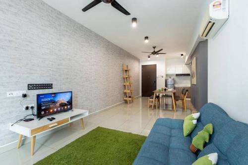 a living room with a blue couch and a tv at Dream - Summer @Majestic Condo in Ipoh