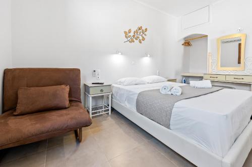 a bedroom with a large bed and a chair at Villa Semipuella in Agios Nikitas