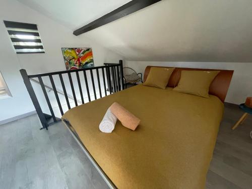 a bedroom with a bed with a towel on it at Le Domaine du Fayé in Étueffont