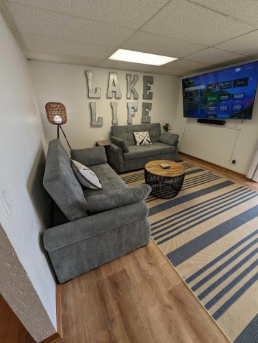 a living room with a couch and a table at 5BR Lakefront Getaway with hot tub in Cadillac