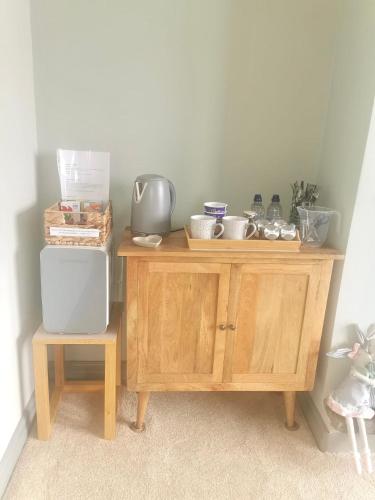 a wooden cabinet with dishes on top of it at No.3 in Cardiff