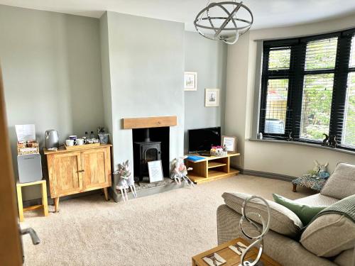 a living room with a couch and a fireplace at No.3 in Cardiff