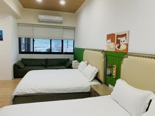a room with two beds and a couch at Good Times BnB in Chishang