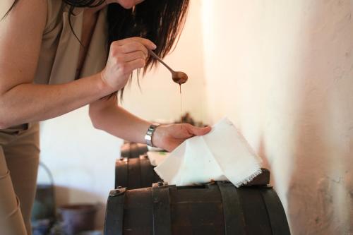 a woman is cutting a cake with a spoon at Villa Messori Spa in Castelvetro di Modena