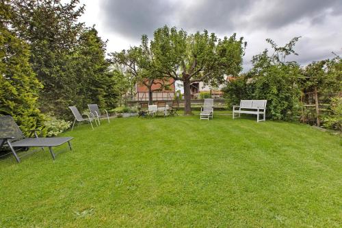 a group of chairs and tables in a yard at Ferienwohnung Bergblick in Veckenstedt