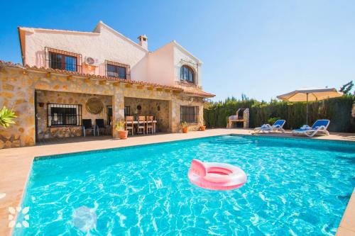 a swimming pool in front of a house at Villa Hugo 11 by Abahana Villas in Benissa