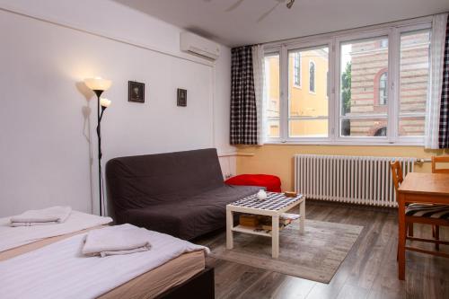 a living room with two beds and a couch at Hedgehog Apartment near Margaret Island in Budapest