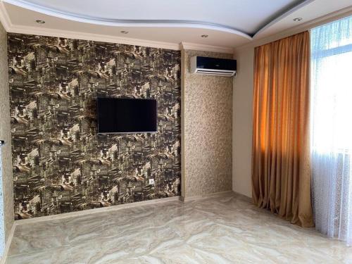 a room with a wall with a tv on it at Art comfort in Rustavi