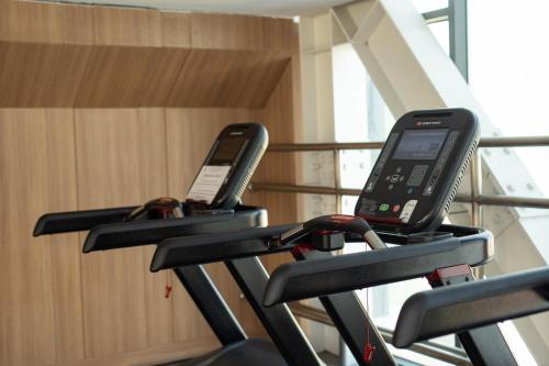 two cell phones on a treadmill in a gym at APARTMENT AIRPORT TAN SON NHAT - free Pool & Gym in Ho Chi Minh City