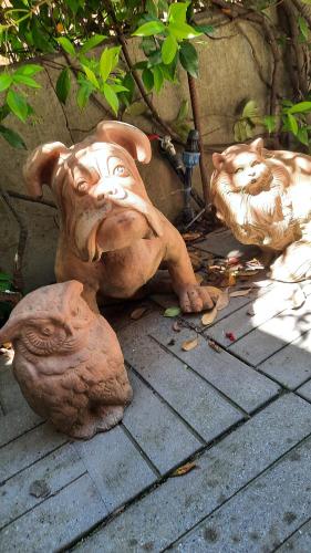 a statue of a dog laying on the ground at San Lorenzo 66 in San Giovanni Valdarno