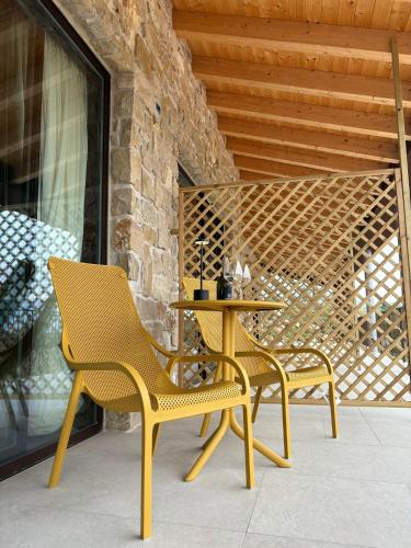 two chairs and a table on a patio at Relais Ca Bago' -adults only in Costermano sul Garda
