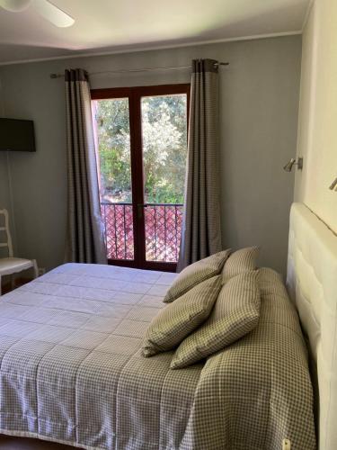 a bedroom with a bed with pillows on it at Les Belles Terrasses in Tourrettes-sur-Loup