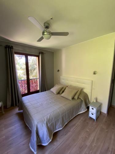 a bedroom with a bed and a ceiling fan at Les Belles Terrasses in Tourrettes-sur-Loup