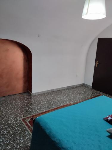 a room with a blue floor next to a door at L' Archè in Castellaneta