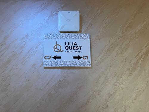 a sign that reads luna quest urgent work on a wooden floor at Lilia Quest in Dakhla