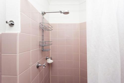 a bathroom with a shower with pink tiles at Bayside Tranquility in Sydney