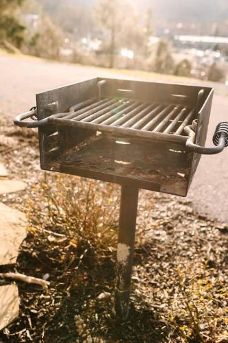 a barbecue grill sitting on the side of a road at Private, Gatlinburg Bliss with Hot Tub and City Views in Gatlinburg