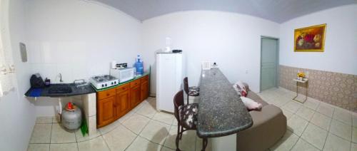 a kitchen with a couch and a counter top at Flat JM in Parauapebas