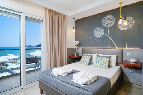 a bedroom with a bed with towels on it at Ester Luxury Rooms in Skala Potamias